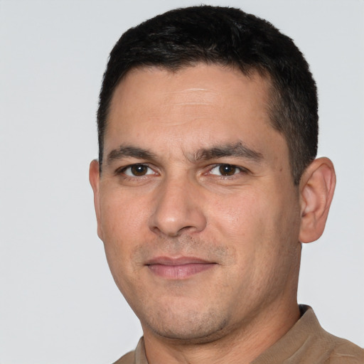 Joyful white adult male with short  black hair and brown eyes