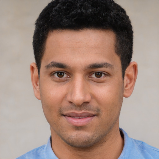Joyful white young-adult male with short  black hair and brown eyes
