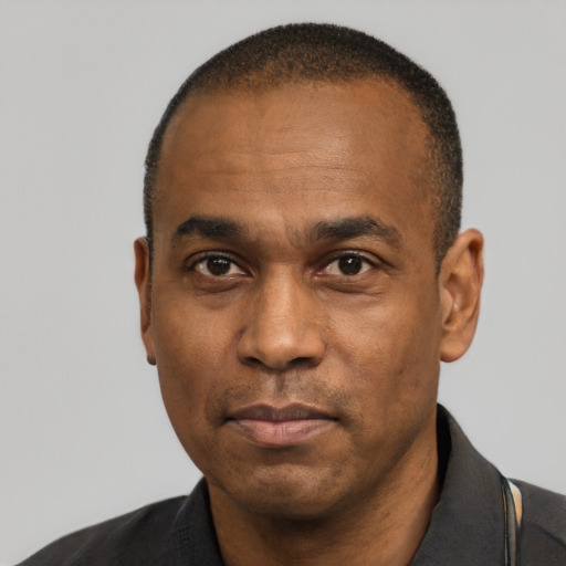 Neutral latino adult male with short  black hair and brown eyes