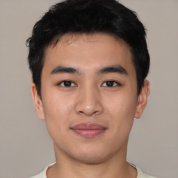 Joyful asian young-adult male with short  black hair and brown eyes