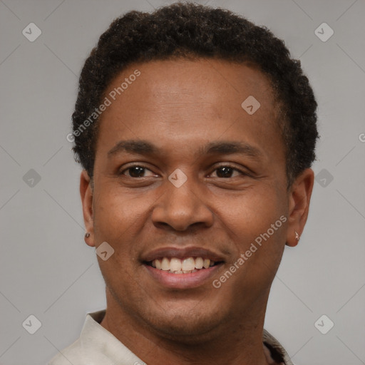 Joyful black young-adult male with short  brown hair and brown eyes