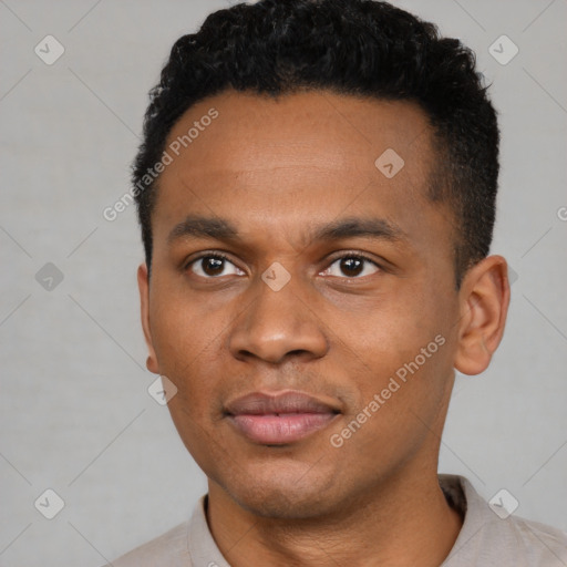 Joyful black young-adult male with short  black hair and brown eyes