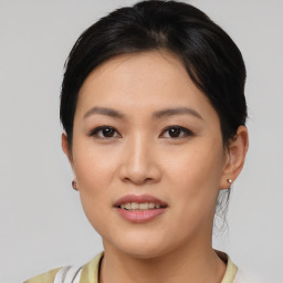 Joyful asian young-adult female with short  brown hair and brown eyes