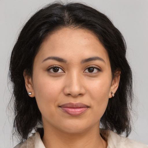 Joyful latino young-adult female with medium  brown hair and brown eyes