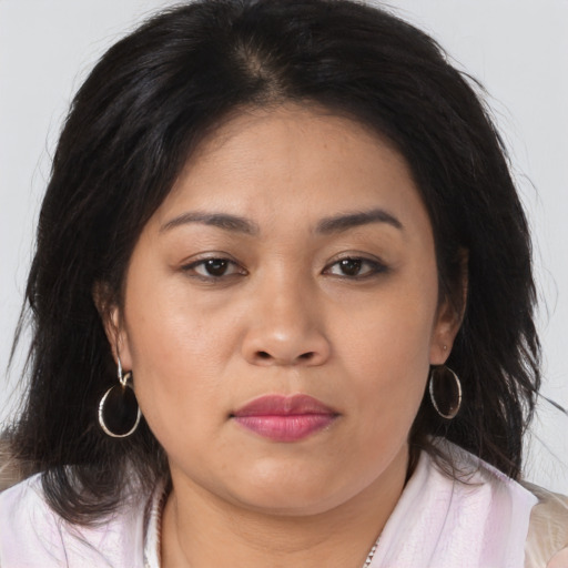 Joyful asian young-adult female with long  brown hair and brown eyes