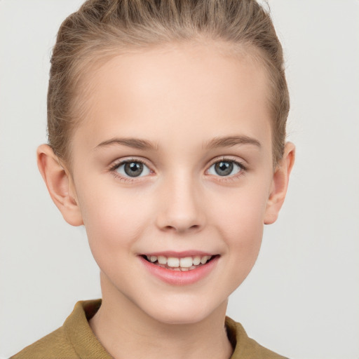 Joyful white child female with short  brown hair and grey eyes