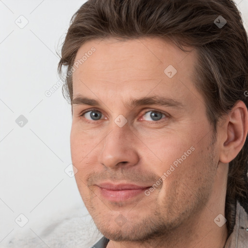 Joyful white adult male with short  brown hair and grey eyes