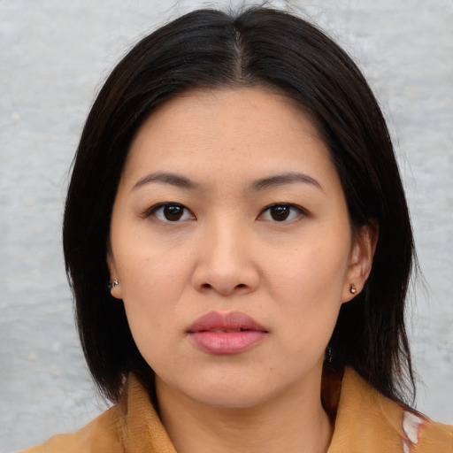 Joyful asian young-adult female with medium  black hair and brown eyes