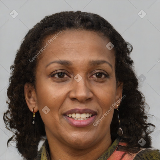 Joyful black adult female with medium  brown hair and brown eyes