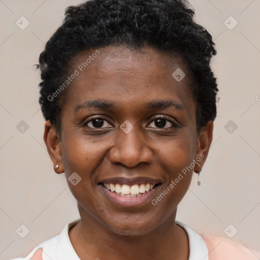 Joyful black young-adult female with short  black hair and brown eyes