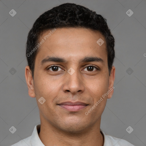 Joyful latino young-adult male with short  brown hair and brown eyes