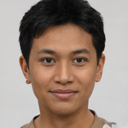 Joyful asian young-adult male with short  black hair and brown eyes