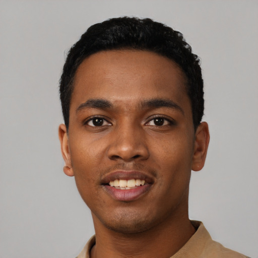 Joyful black young-adult male with short  black hair and brown eyes