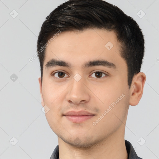 Joyful white young-adult male with short  black hair and brown eyes