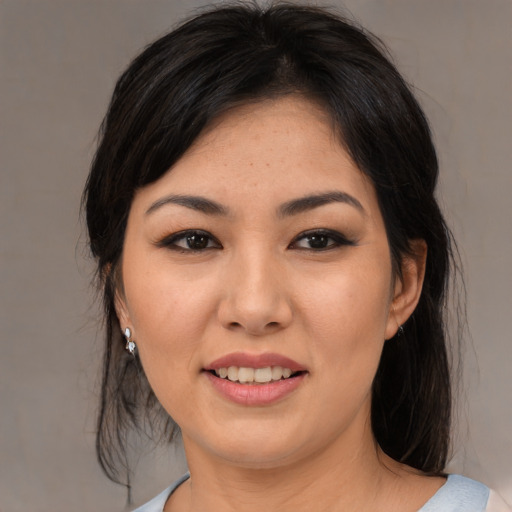 Joyful asian young-adult female with medium  black hair and brown eyes