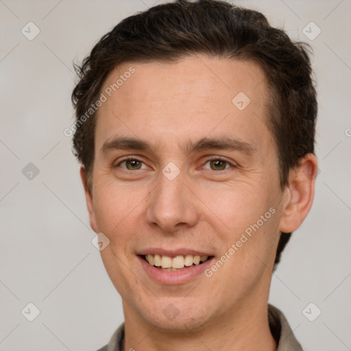 Joyful white adult male with short  brown hair and grey eyes