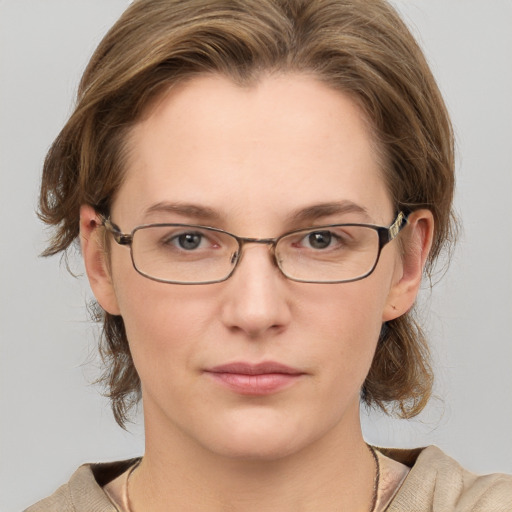 Joyful white adult female with medium  brown hair and grey eyes