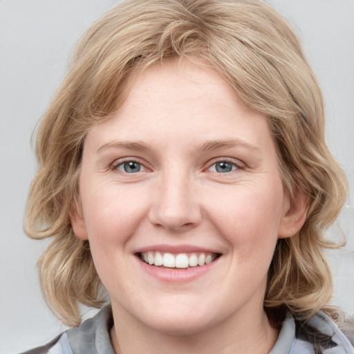 Joyful white young-adult female with medium  brown hair and blue eyes