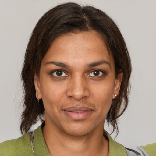 Joyful black young-adult female with medium  brown hair and brown eyes