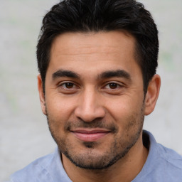 Joyful white young-adult male with short  black hair and brown eyes