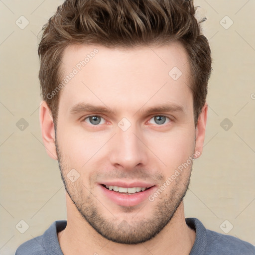 Joyful white young-adult male with short  brown hair and grey eyes