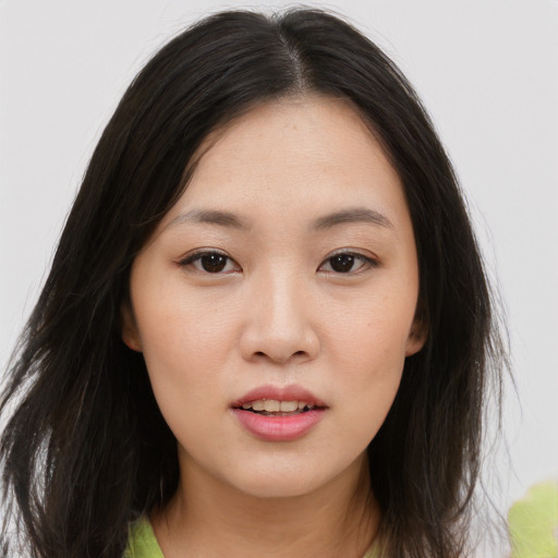 Joyful asian young-adult female with long  brown hair and brown eyes