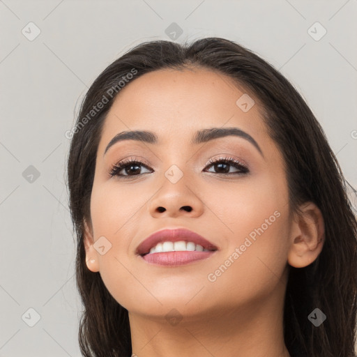 Joyful latino young-adult female with long  brown hair and brown eyes