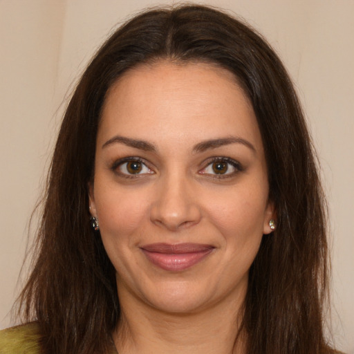 Joyful white young-adult female with long  brown hair and brown eyes