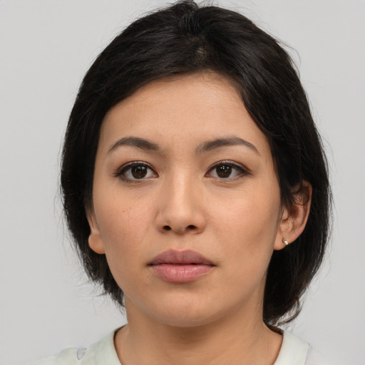 Neutral asian young-adult female with medium  brown hair and brown eyes