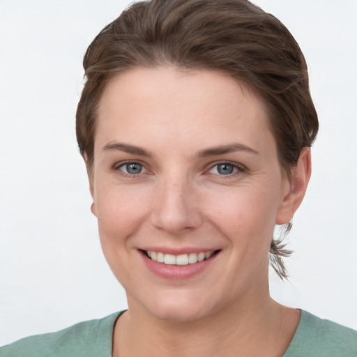 Joyful white young-adult female with short  brown hair and grey eyes