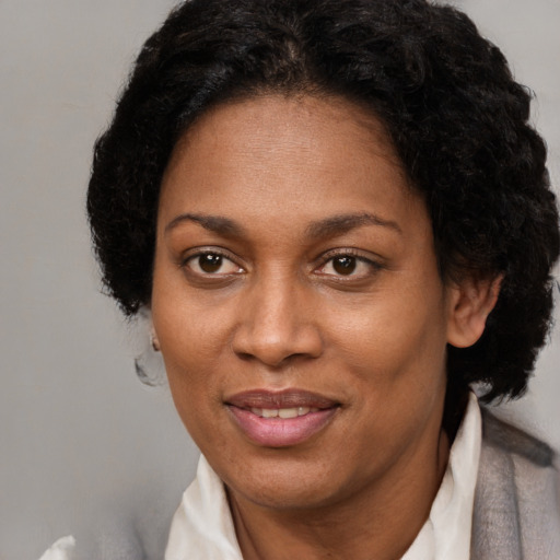 Joyful black adult female with short  brown hair and brown eyes