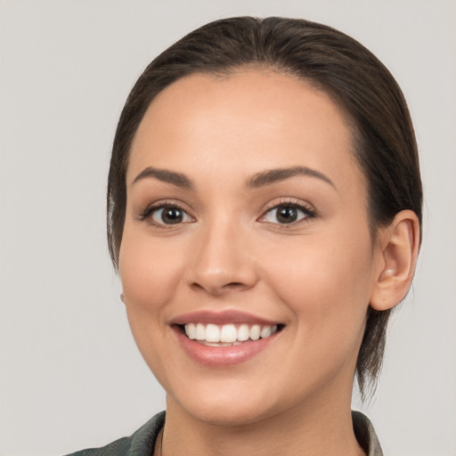 Joyful white young-adult female with medium  brown hair and brown eyes