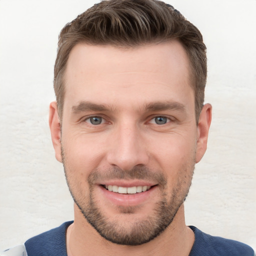 Joyful white young-adult male with short  brown hair and grey eyes