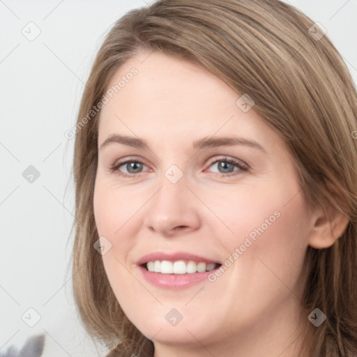 Joyful white young-adult female with long  brown hair and grey eyes