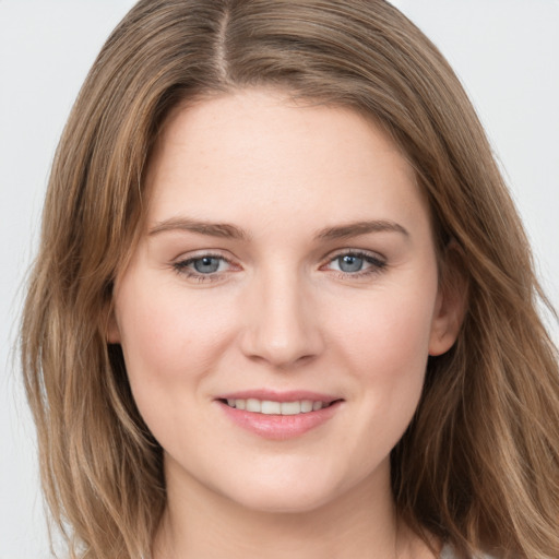 Joyful white young-adult female with long  brown hair and grey eyes