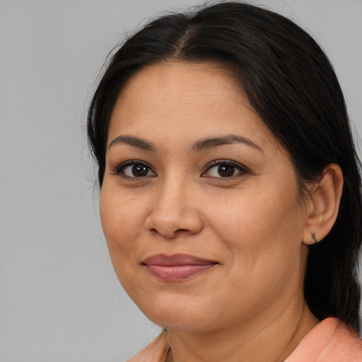 Joyful asian adult female with medium  brown hair and brown eyes