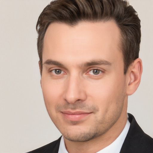 Joyful white young-adult male with short  brown hair and brown eyes