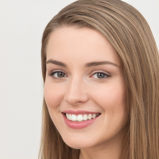 Joyful white young-adult female with long  brown hair and green eyes