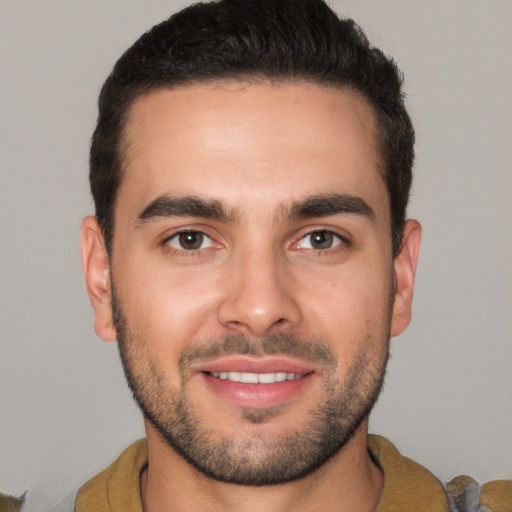 Joyful white young-adult male with short  brown hair and brown eyes