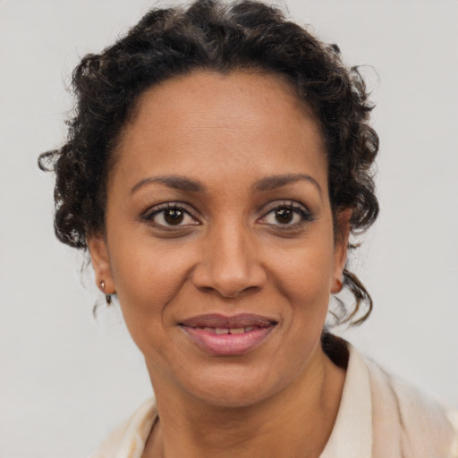 Joyful black adult female with short  brown hair and brown eyes
