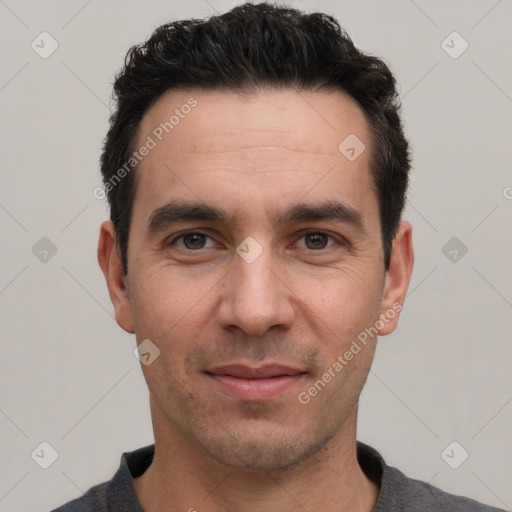 Joyful white young-adult male with short  black hair and brown eyes