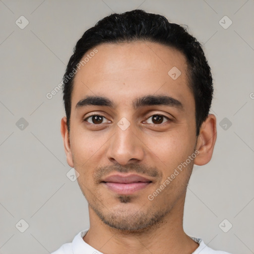 Joyful latino young-adult male with short  black hair and brown eyes