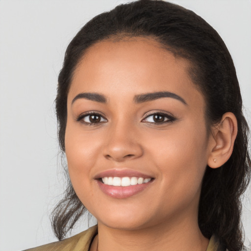 Joyful latino young-adult female with long  black hair and brown eyes