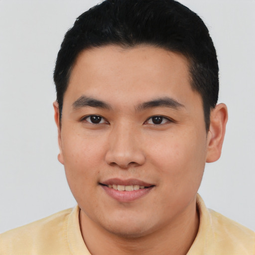 Joyful asian young-adult male with short  black hair and brown eyes