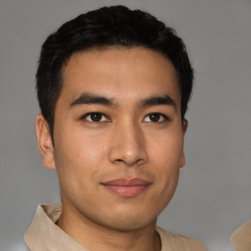 Joyful latino young-adult male with short  black hair and brown eyes