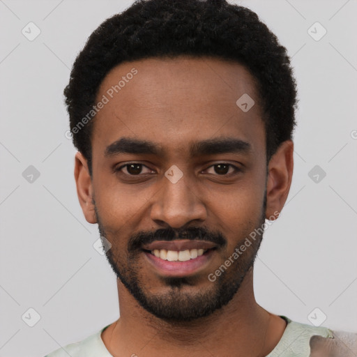 Joyful black young-adult male with short  black hair and brown eyes