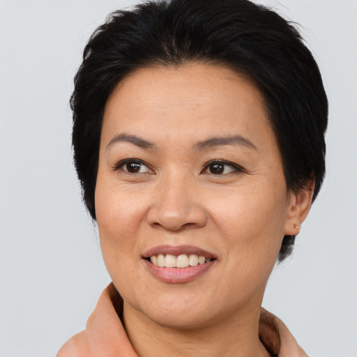Joyful asian adult female with medium  brown hair and brown eyes