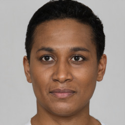 Joyful black young-adult female with short  black hair and brown eyes
