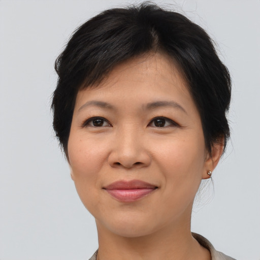 Joyful asian adult female with medium  brown hair and brown eyes