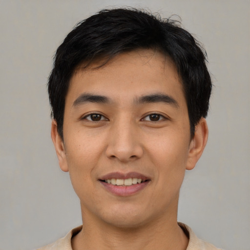 Joyful asian young-adult male with short  black hair and brown eyes